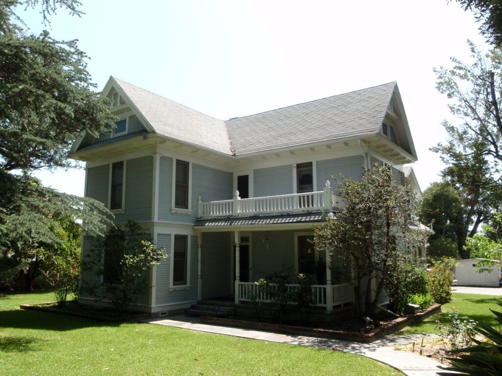 A victorian style house with a porch.