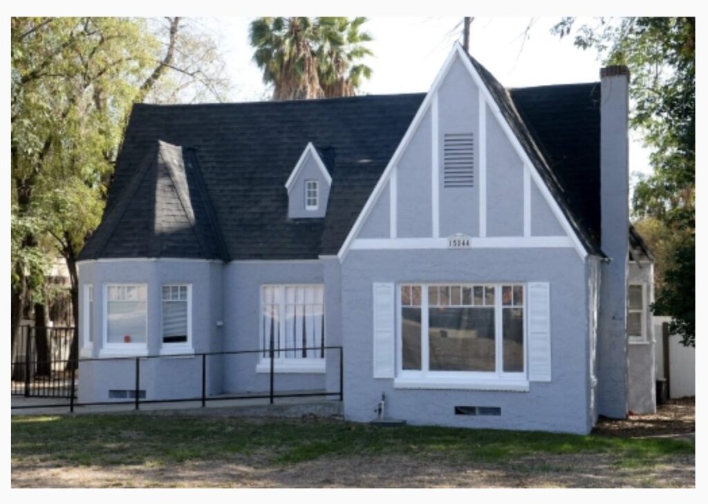 A house with a blue roof and white trim.